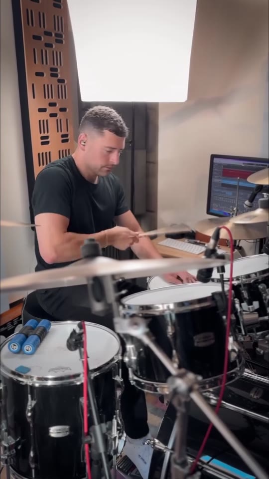 Max Saidi playing drums in his studio