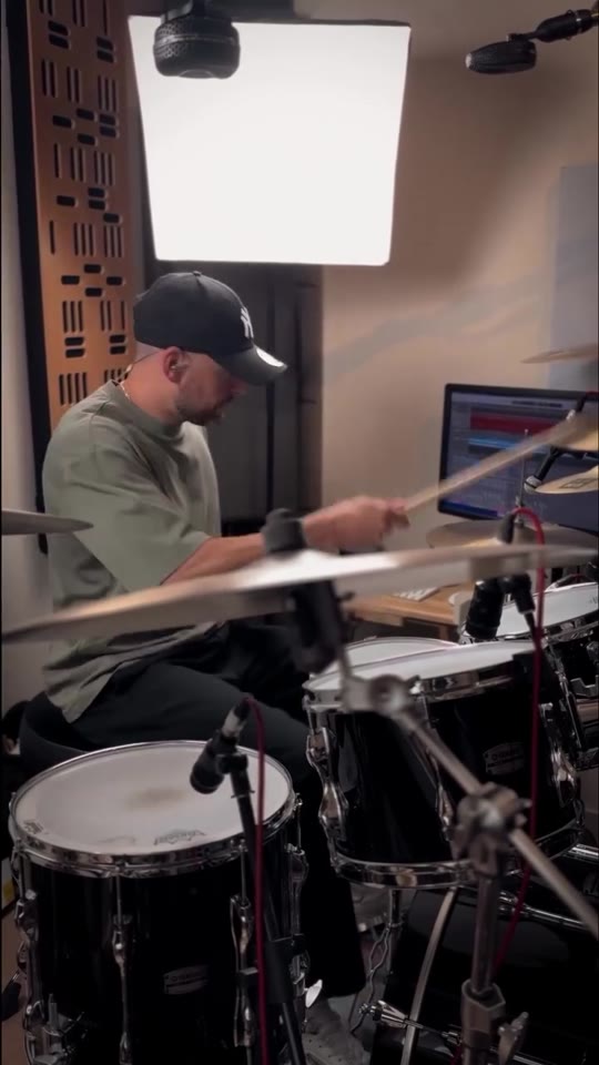 Max Saidi playing drums in his studio