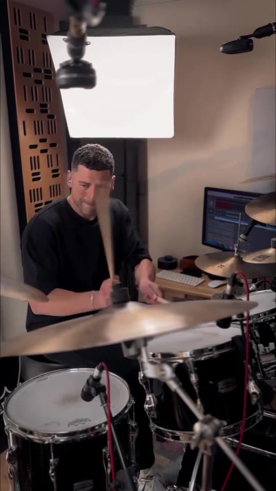 Max Saidi playing drums in his studio