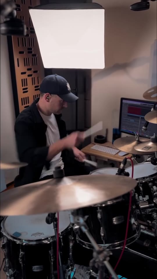Max Saidi playing drums in his studio
